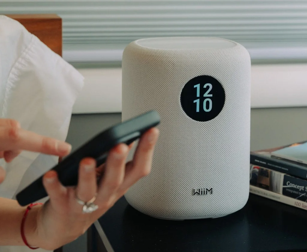 WiiM Sound with the WiiM Home app on a phone